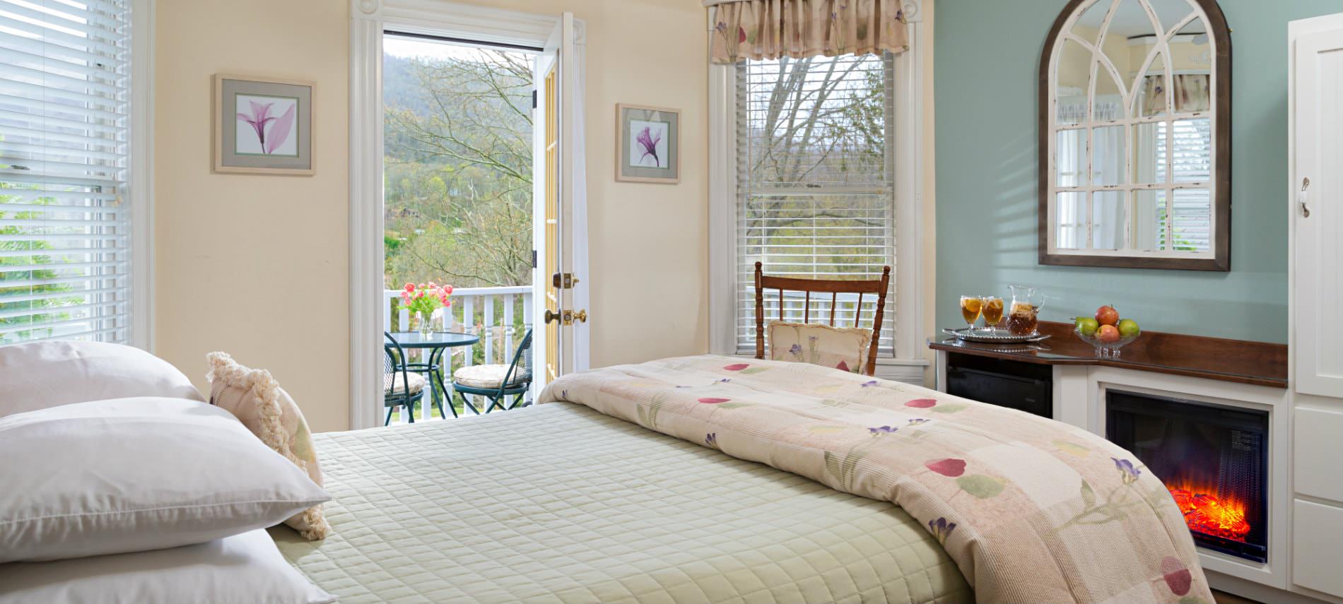 Mountain View Room bedroom with queen size bed, private porch and electric fireplace