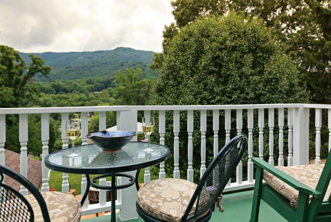 Mountain View Room private porch with cafe table & chairs and double glider