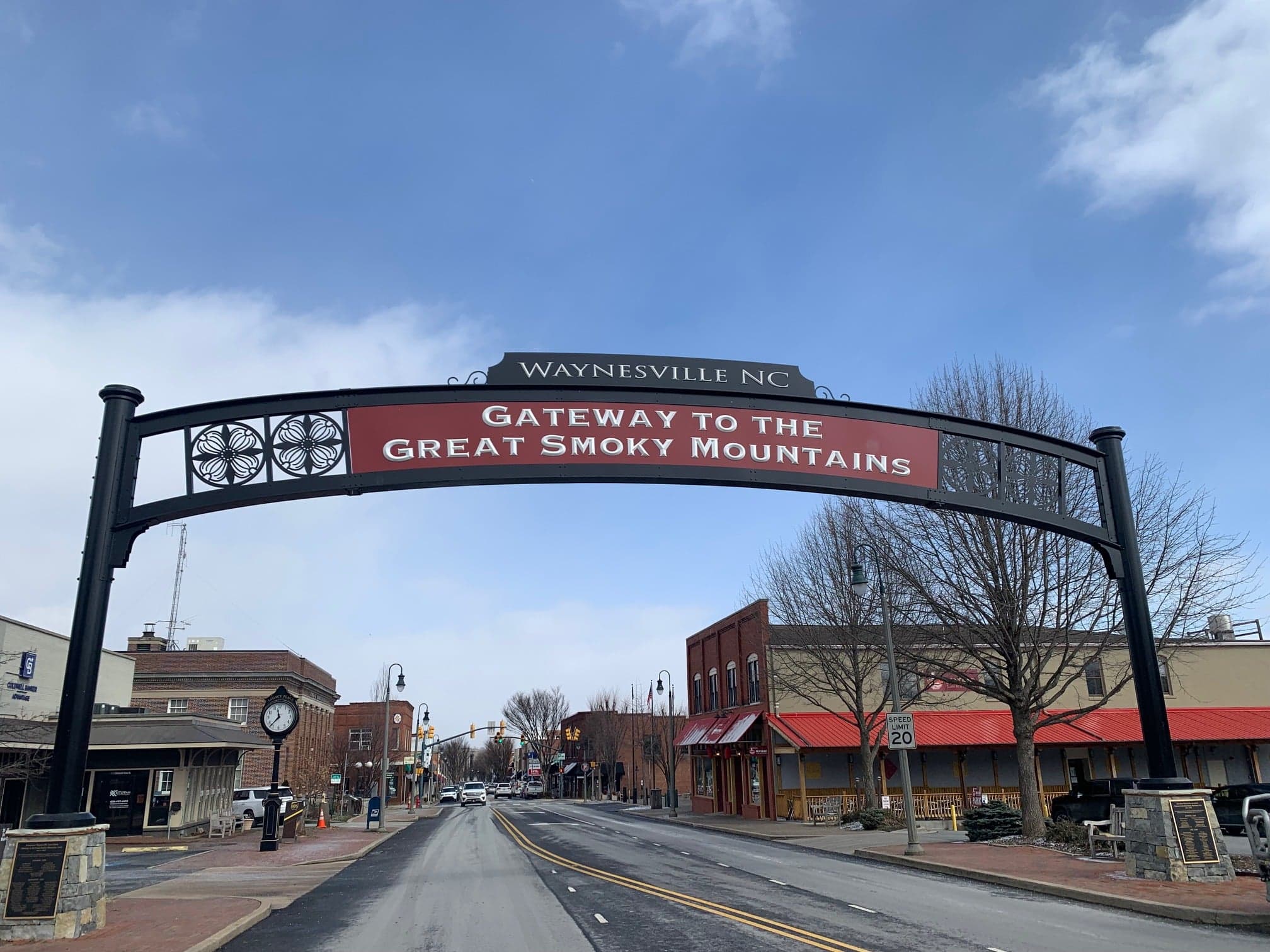 A sign archway reads "Gateway to the Great Smoky Mountains" in Waynesville, NC.