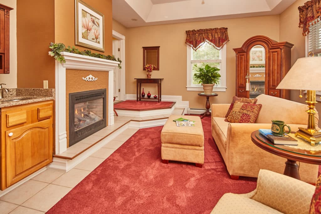 Cozy living room featuring a fireplace, plush seating, and decorative accents.