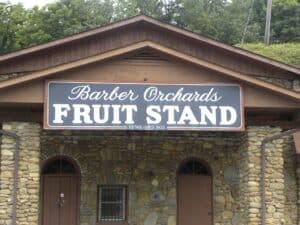 Sign for Barber Orchards Fruit Stand on a rustic building.