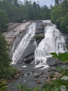 A cascading waterfall surrounded by lush greenery.