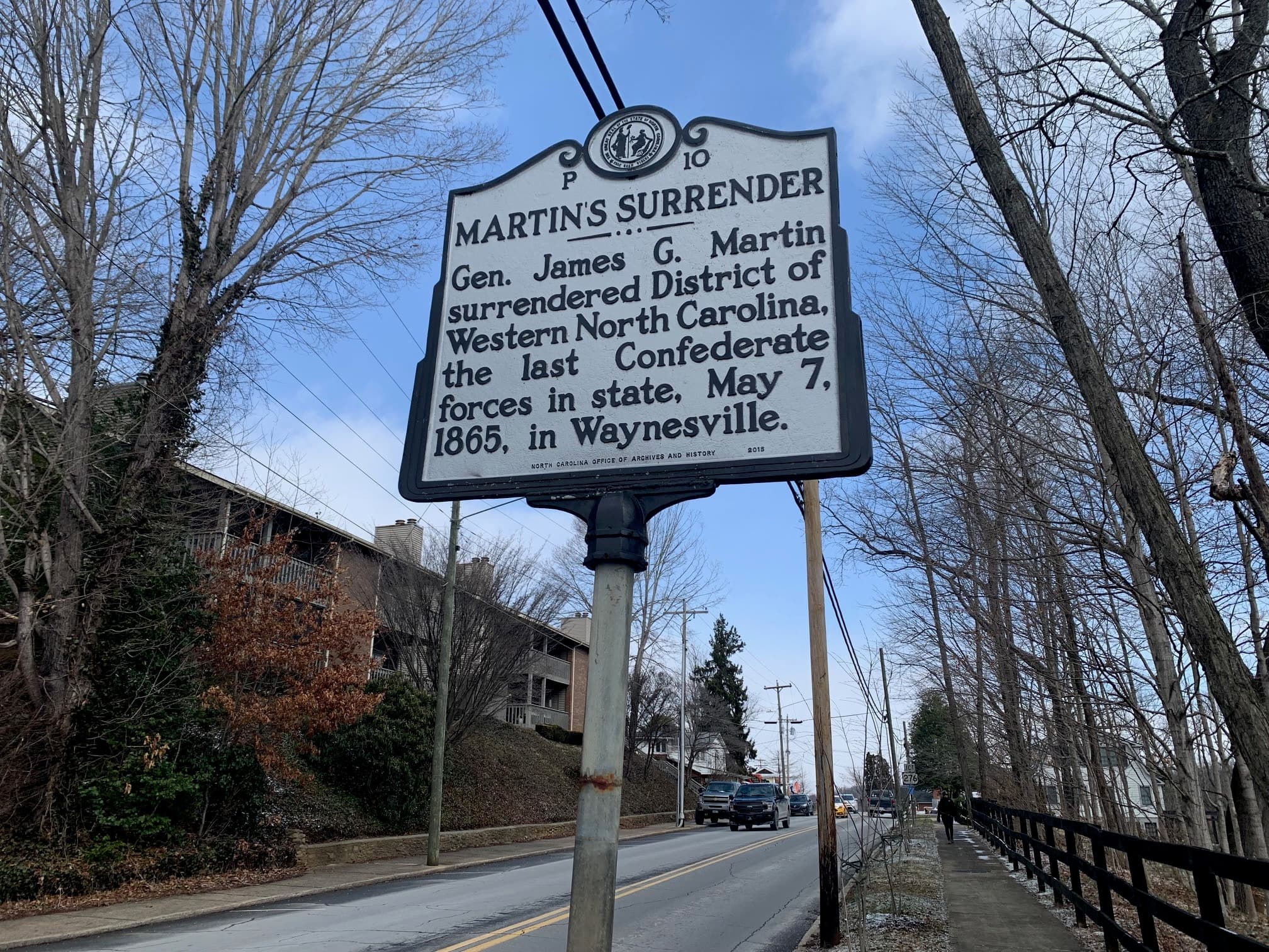 A historical marker titled "Martin's Surrender" detailing General James G. Martin's surrender of Confederate forces on May 7, 1865, in Waynesville, North Carolina. A historical marker titled "Martin's Surrender" detailing General James G. Martin's surrender of Confederate forces on May 7, 1865, in Waynesville, North Carolina.