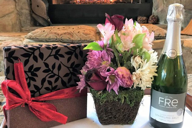Deluxe celebration package with flowers chocolate truffles and non-alcoholic sparkling wine