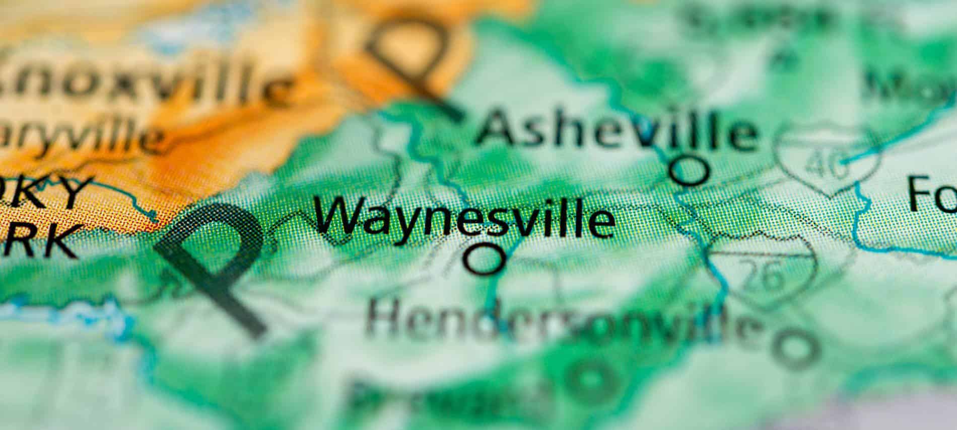 Close up view of a yellow and green shaded map of Waynesville, NC and the surrounding towns