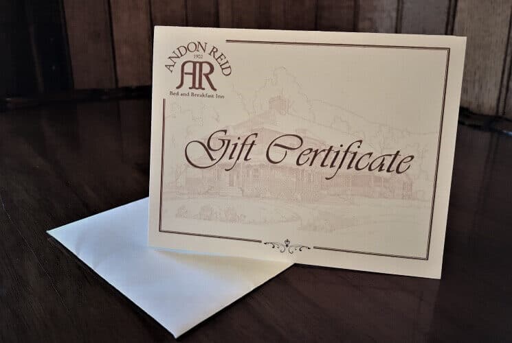 Cream and white card for a gift certificate on a table on top of a white envelope